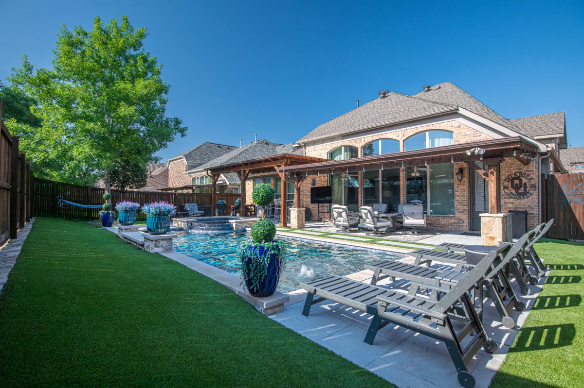 Beautiful residential home with manicured green lawn and landscaping