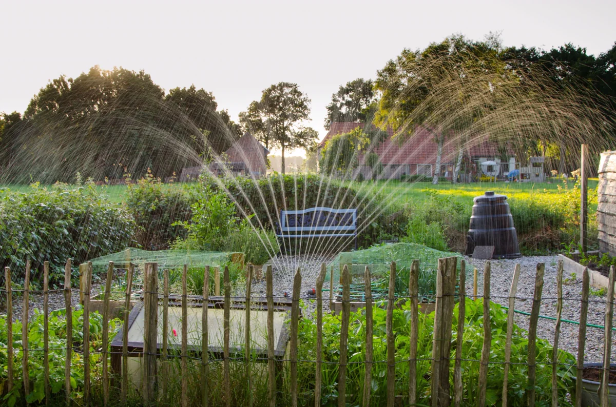 Irrigation sprinkler system running in a green garden